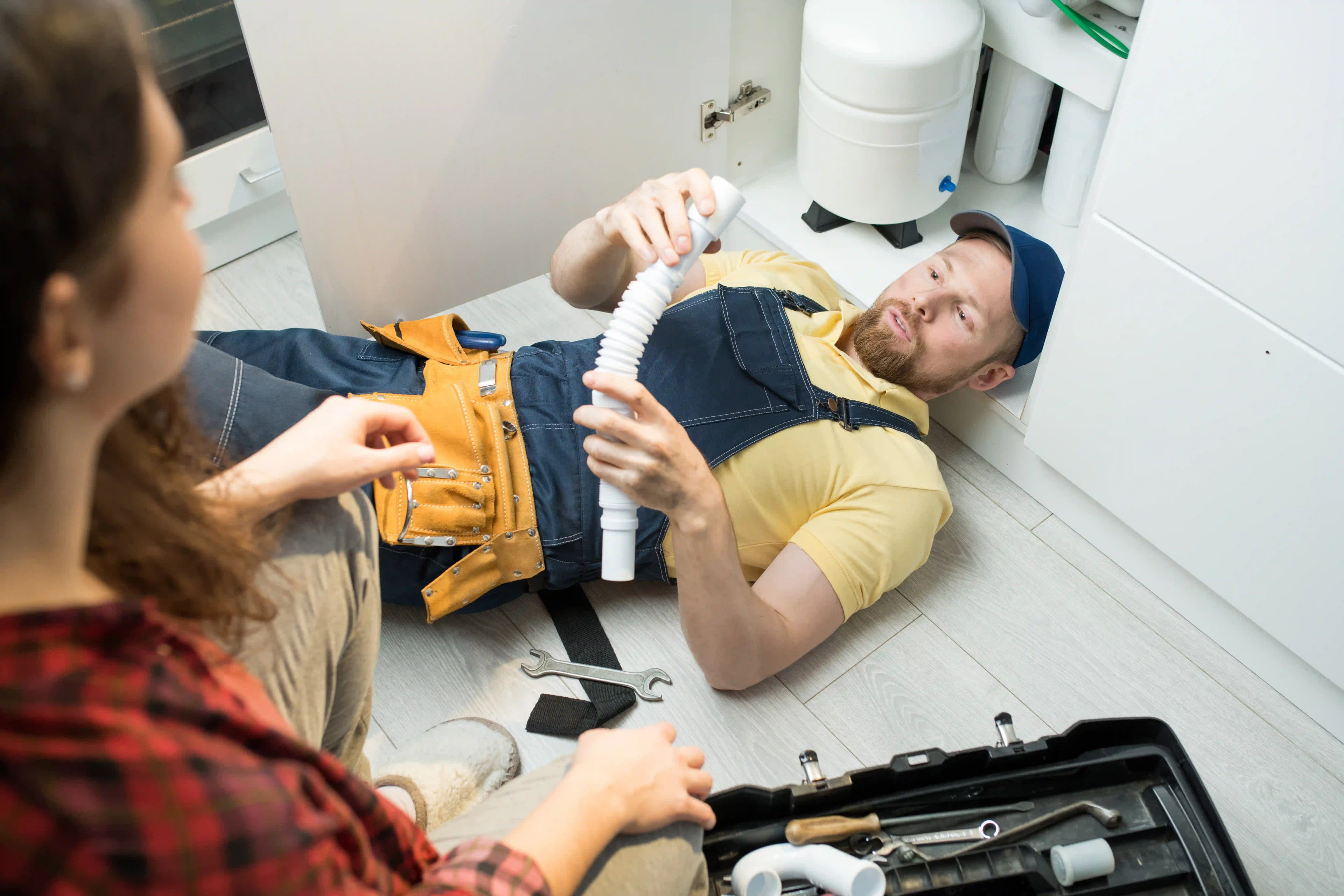 young-plumber-changing-trap-under-sink